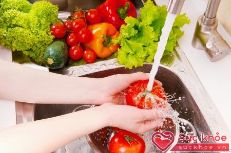 Rửa rau, quả dưới vòi nước chảy là cách phòng tránh ngộ độc hiệu quả.
